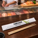 Bamboo chopsticks in a custom printed paper chopstick sleeve – custom printed packaging by Texas Food Pack