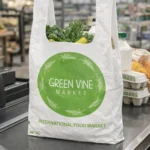 Custom printed white t-shirt plastic carryout bag at a grocery checkout – custom printed packaging by Texas Food Pack