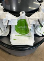 Custom printed t-shirt plastic bags on a dispenser rack – custom printed packaging by Texas Food Pack
