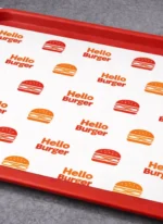 Custom printed tray liner paper on a red food tray – custom printed packaging by Texas Food Pack