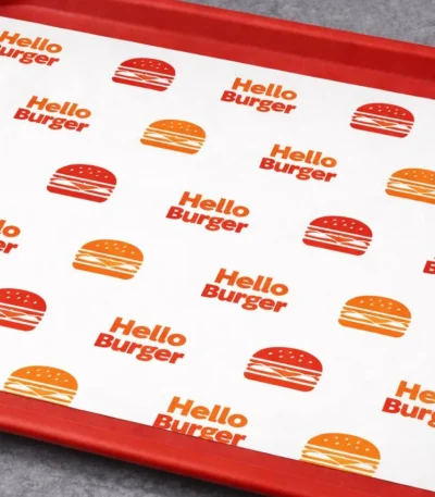 Custom printed tray liner paper on a red food tray – custom printed packaging by Texas Food Pack